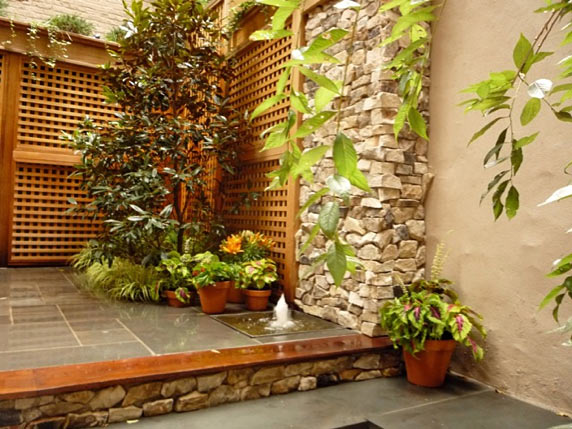 stone patio with stone wall detail and fountain